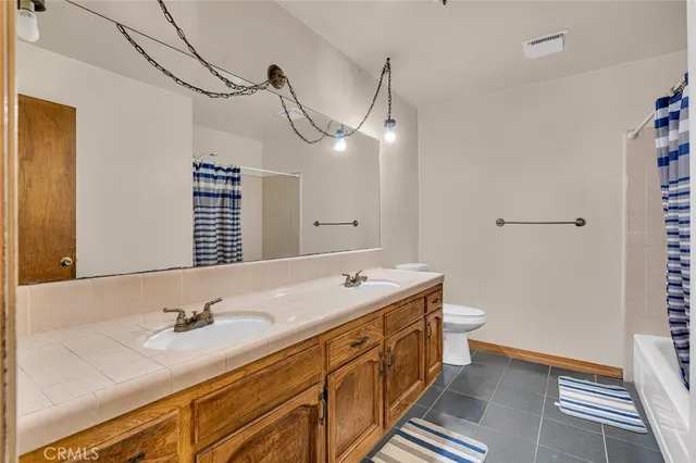 a bathroom with a sink double vanity and a shower