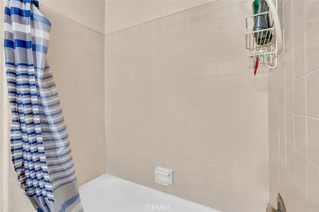 a bathroom with a toilet and a shower curtain