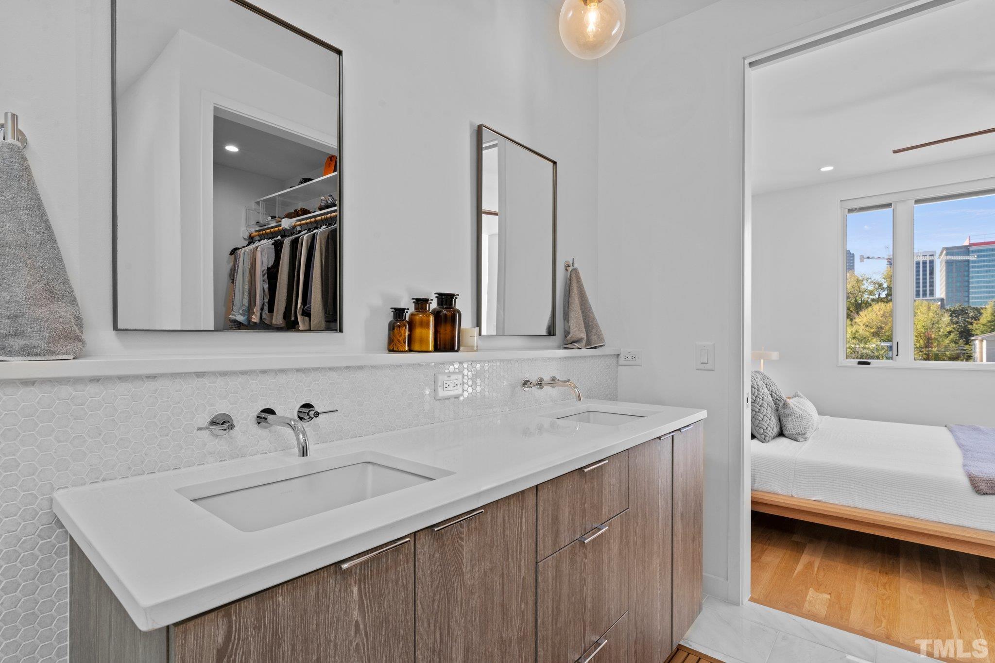 426 Chavis Way Raleigh, NC 27601 - Photo 23 of 35 a en suite bathroom with a sink and a mirror