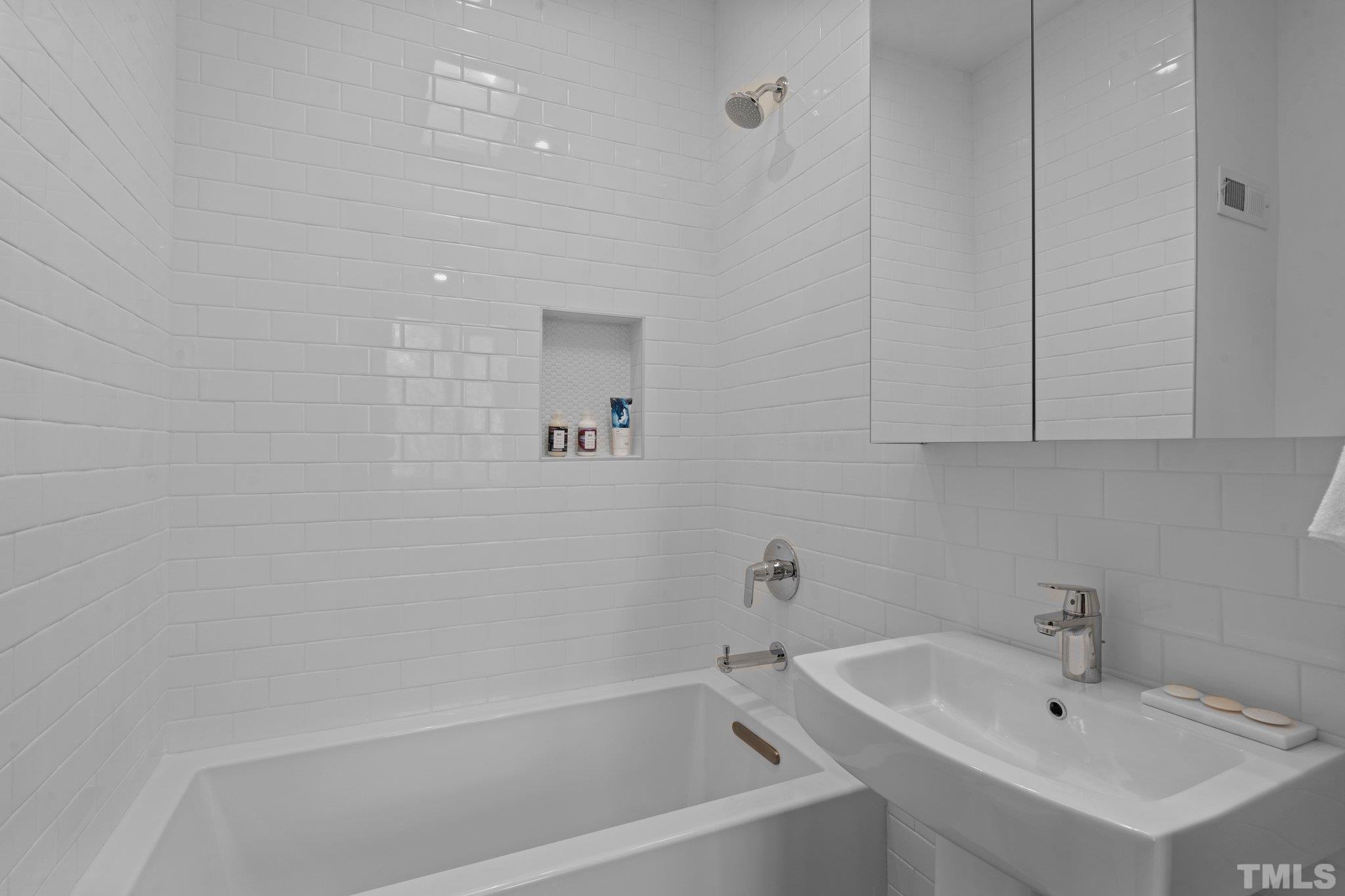 426 Chavis Way Raleigh, NC 27601 - Photo 26 of 35 a white bath tub sitting next to a white sink and vanity