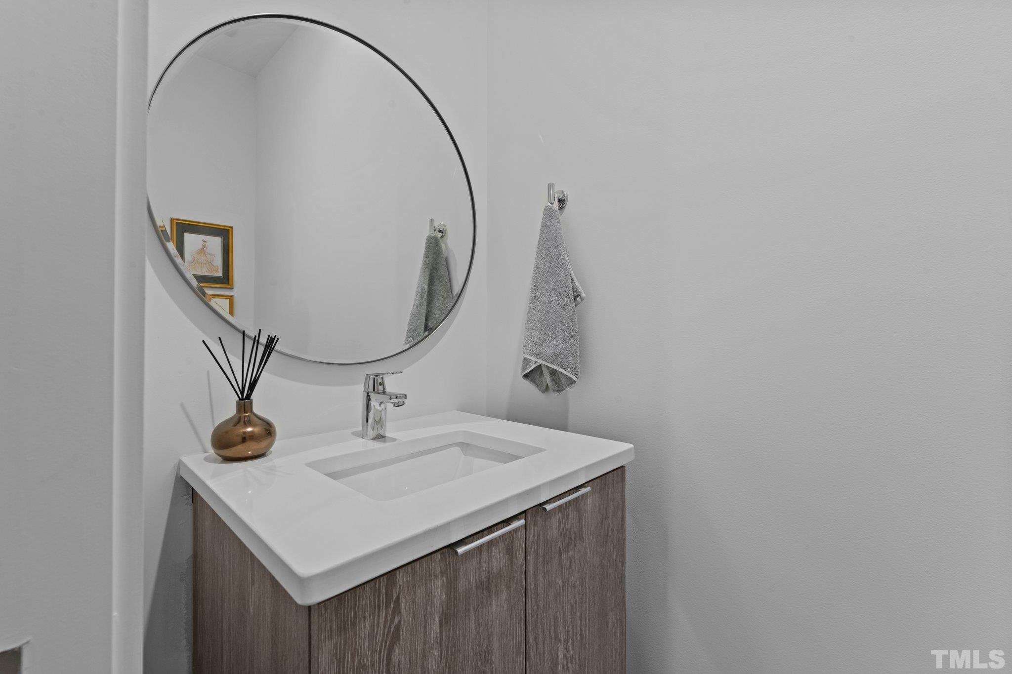 426 Chavis Way Raleigh, NC 27601 - Photo 31 of 35 a bathroom with a sink and a mirror