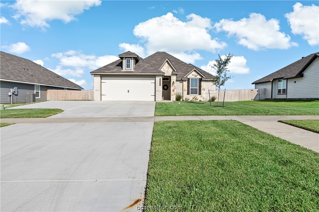 a front view of a house with garden