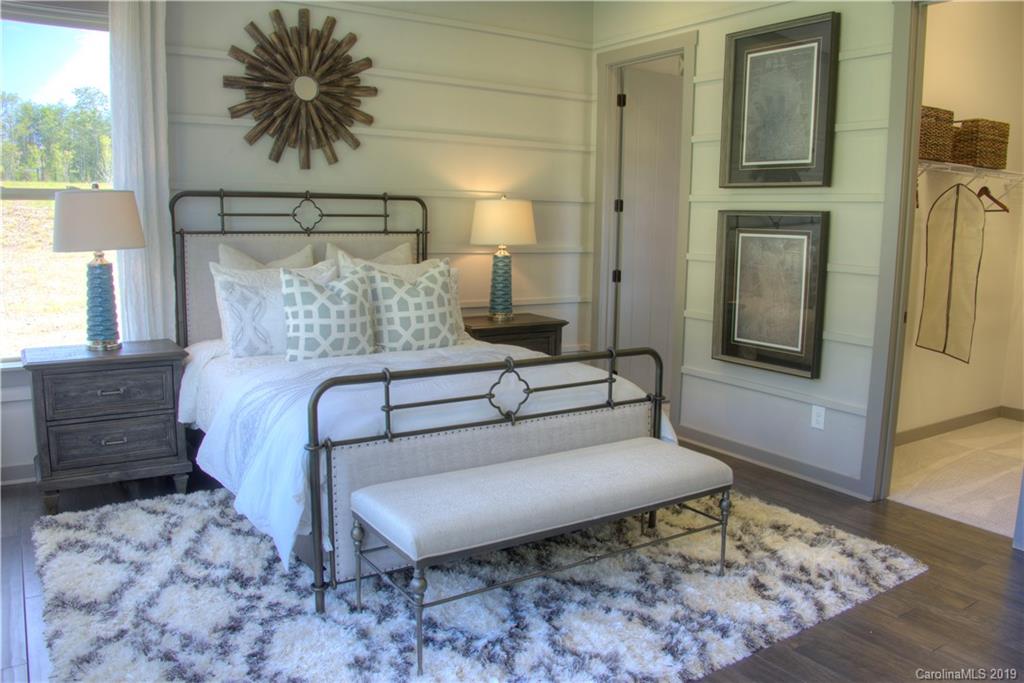 4022 Oarman Court, Unit 437 Fort Mill, SC 29708 - Photo 7 of 13 a bedroom with a bed and a table in it