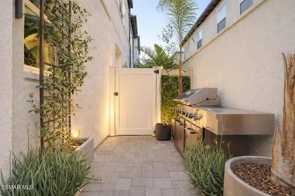 a view of a pathway of a house with flower plants