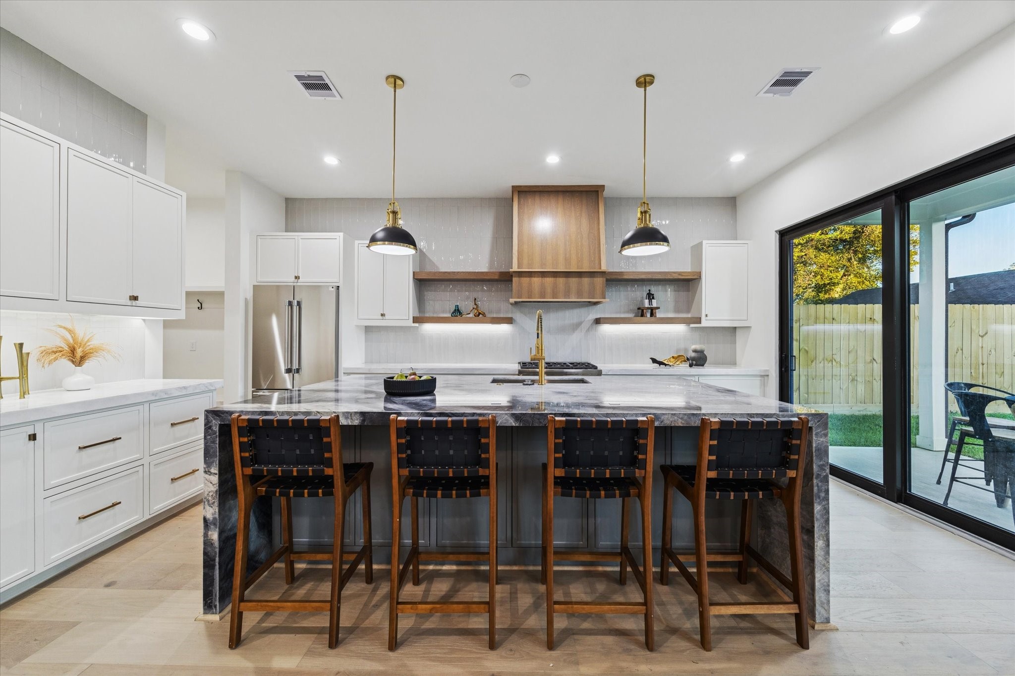 614 Eleanor Street Houston, TX 77009 - Photo 14 of 43 a kitchen with stainless steel appliances kitchen island granite countertop a table chairs sink and cabinets
