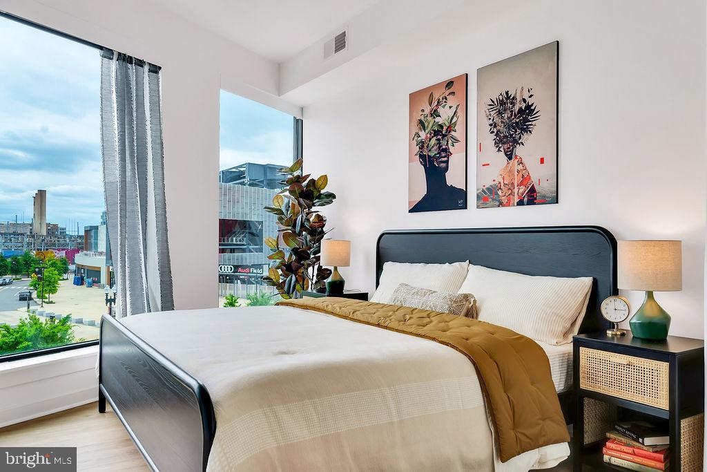 113 Potomac Avenue Southwest, Unit 508 Washington, DC 20024 - Photo 10 of 50 a bedroom with a bed and a painting on the wall
