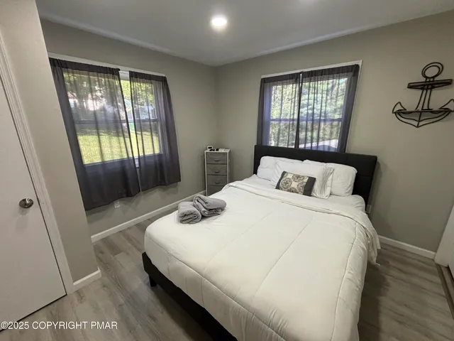 a kitchen with stainless steel appliances granite countertop a refrigerator a stove a sink and a microwave