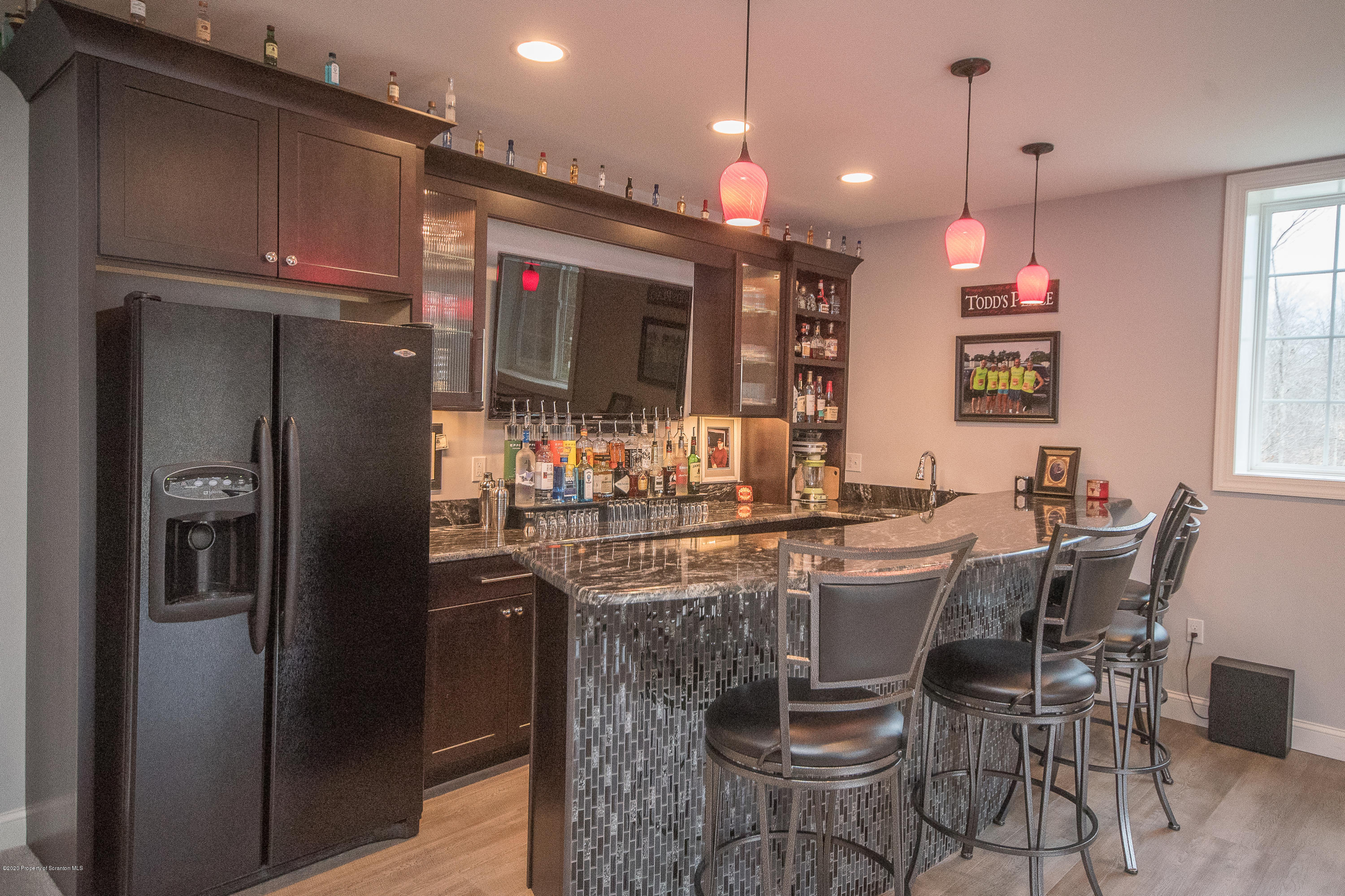 121 Highland Road Moscow, PA 18444 - Photo 44 of 93 a kitchen with stainless steel appliances granite countertop a refrigerator a sink a stove a dining table and chairs