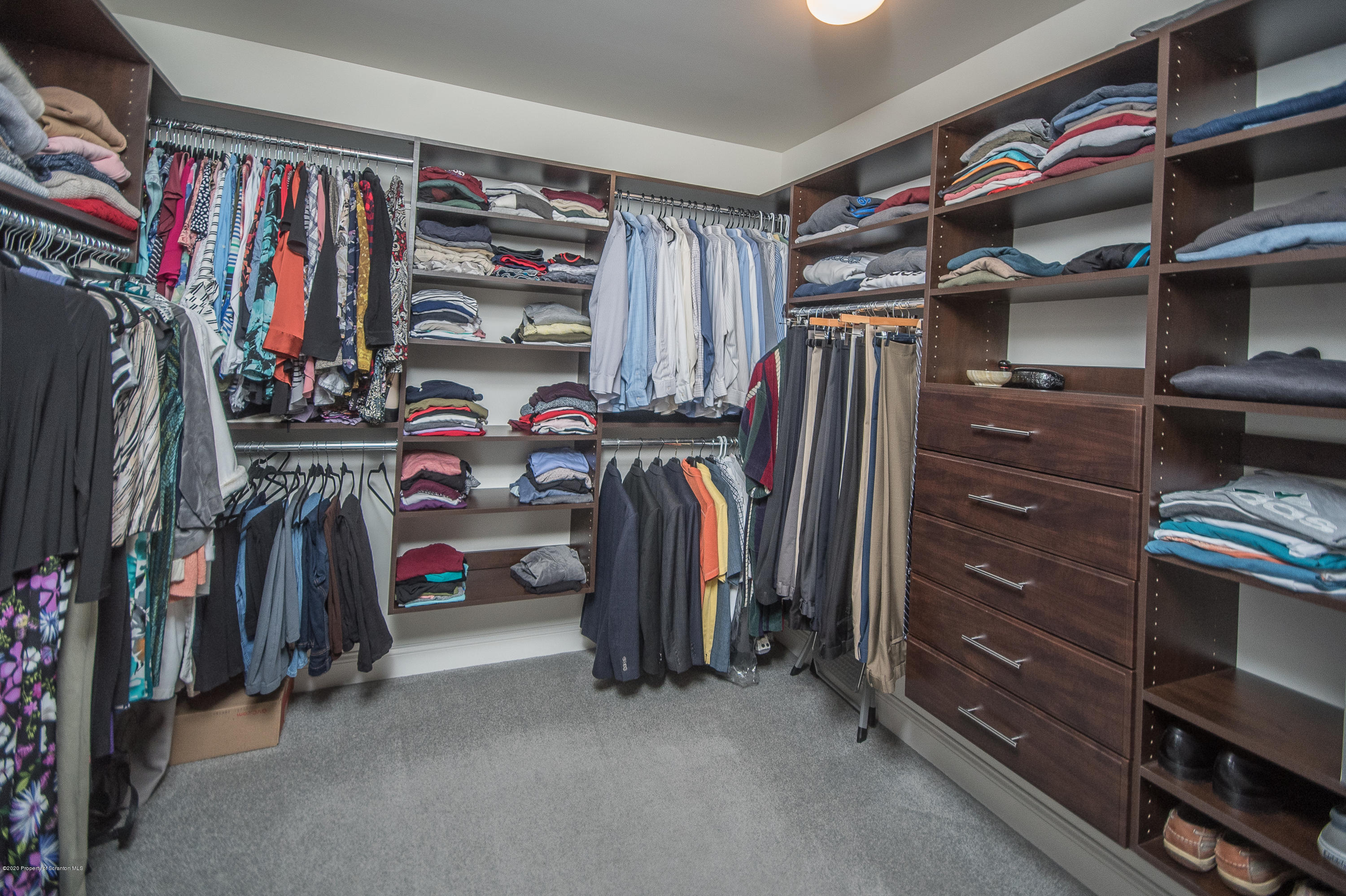 121 Highland Road Moscow, PA 18444 - Photo 50 of 93 a view of walk in closet with clothes and shoes