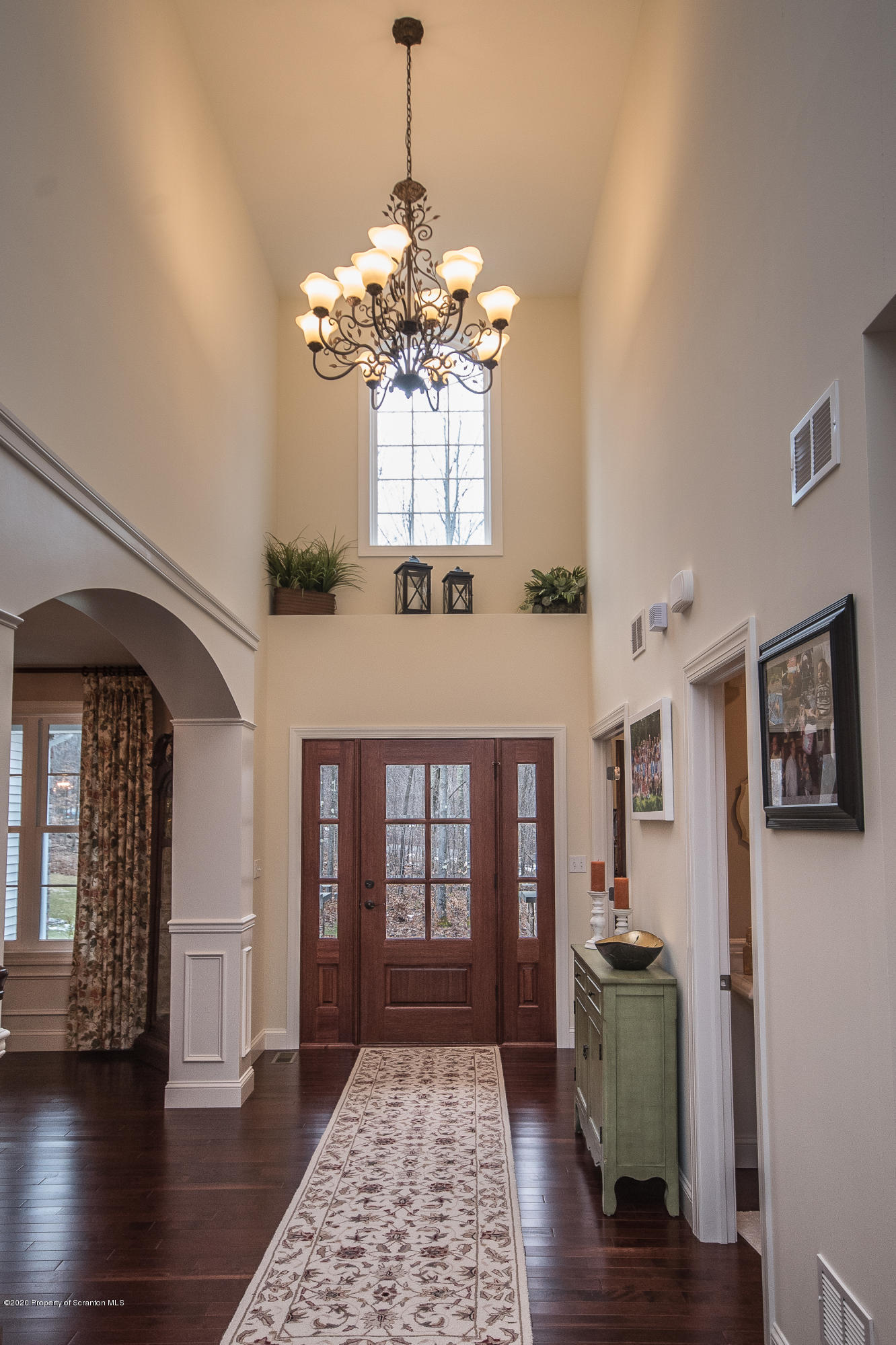 121 Highland Road Moscow, PA 18444 - Photo 5 of 93 a view of a livingroom with wooden floor and a chandelier