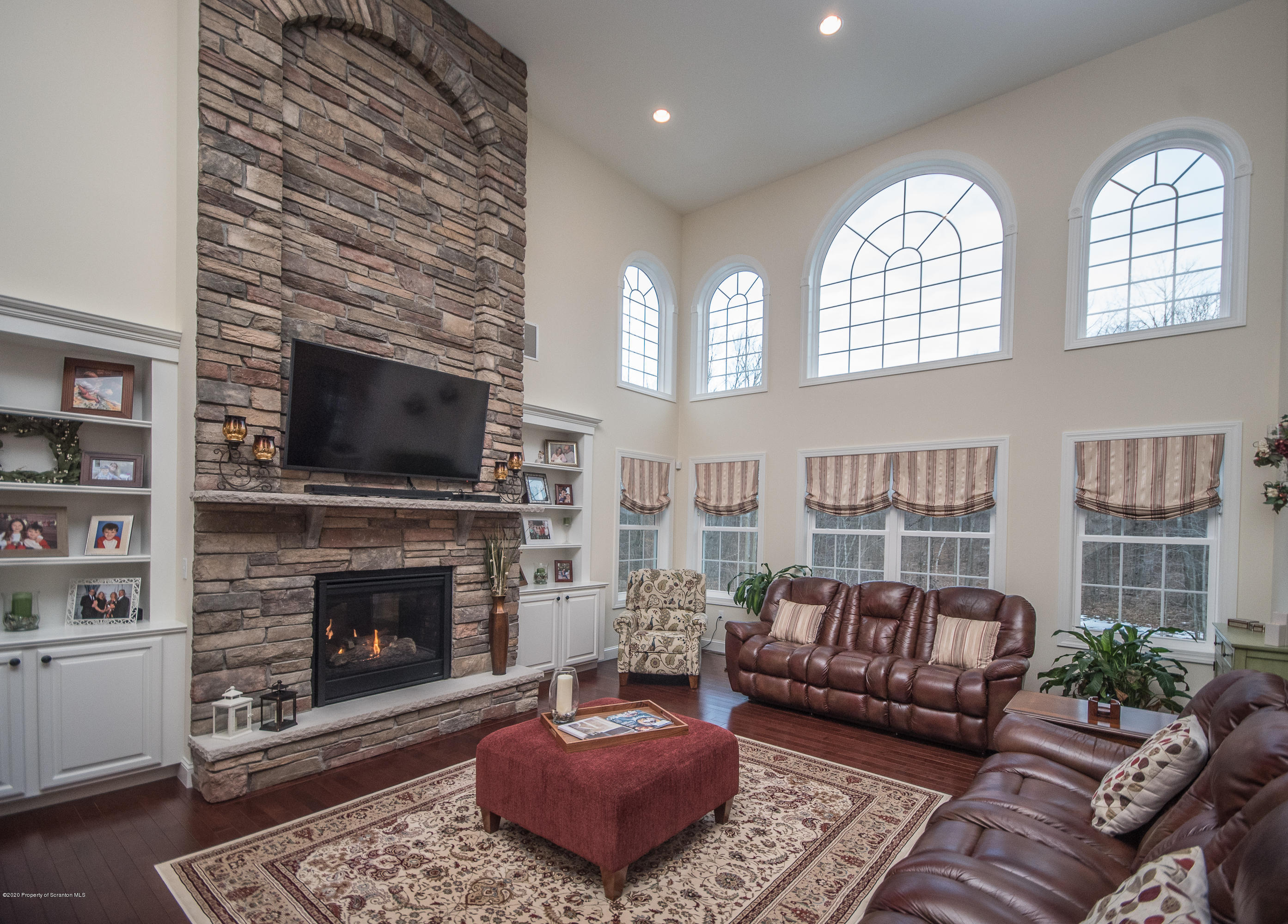 121 Highland Road Moscow, PA 18444 - Photo 7 of 93 a living room with furniture a fireplace and a flat screen tv
