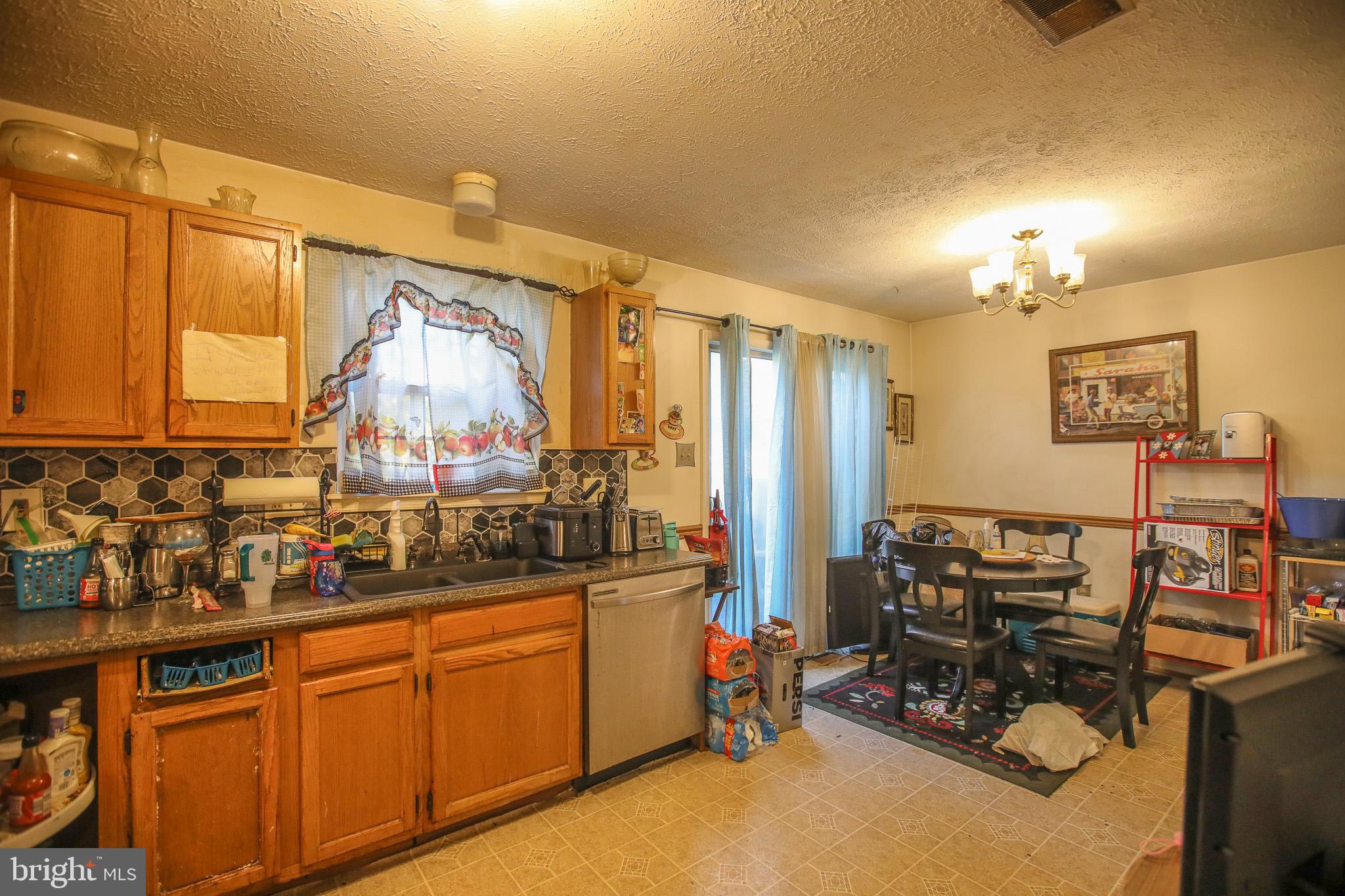 506 Imperial Square Odenton, MD 21113 - Photo 4 of 14 a view of a kitchen with kitchen island granite countertop a sink cabinets and appliances