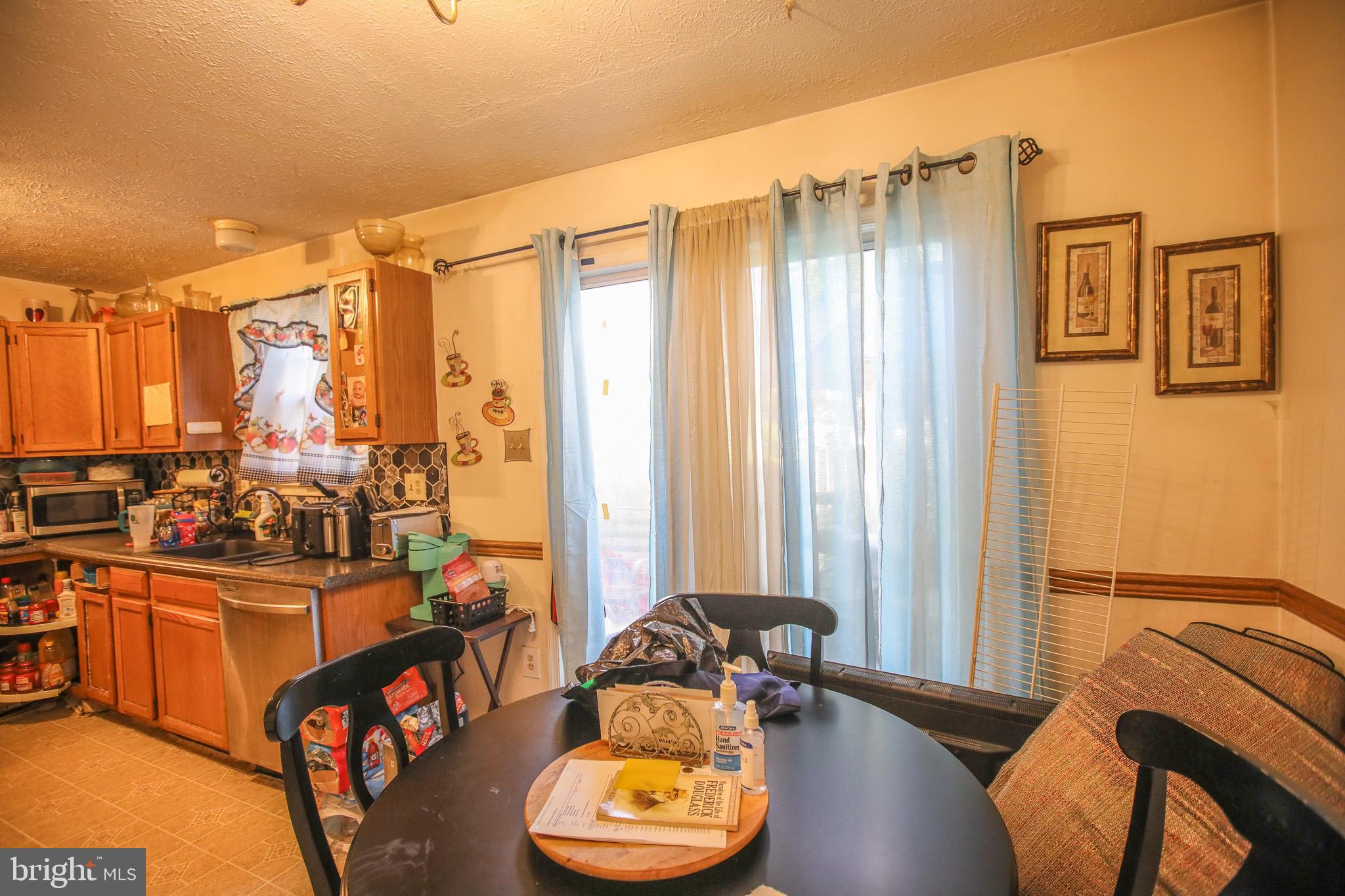 506 Imperial Square Odenton, MD 21113 - Photo 5 of 14 a view of a livingroom with furniture and a floor to ceiling window