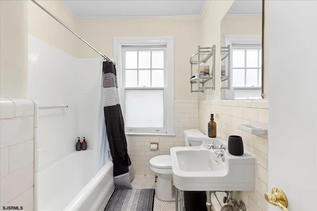 a bathroom with a sink a toilet and tub