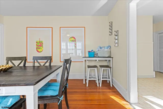 a dining room with furniture and wooden floor