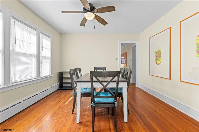 a dining room with furniture and wooden floor
