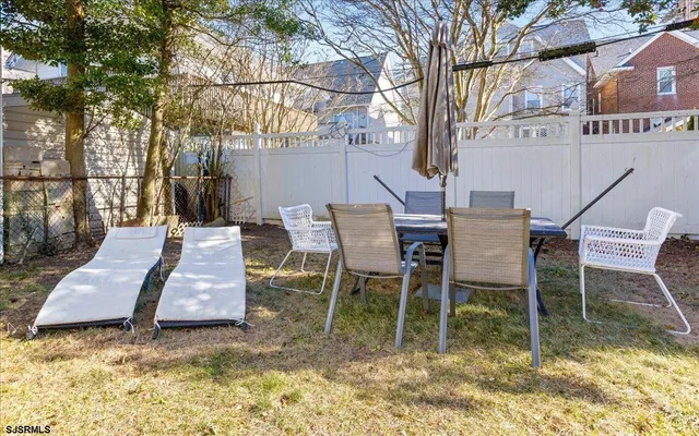 a backyard of a house with table and chairs
