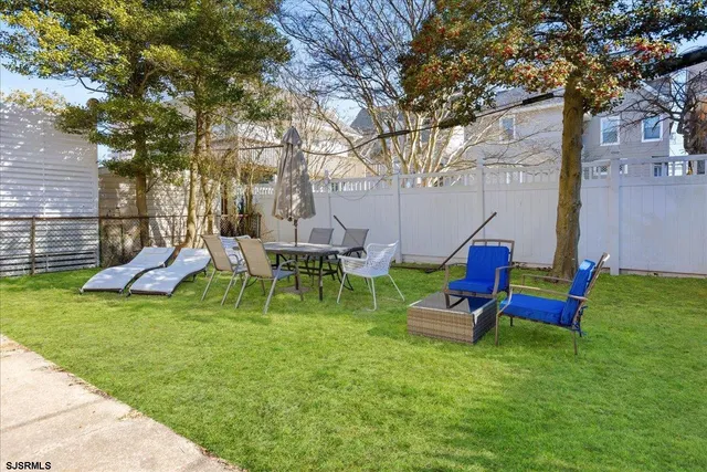 a backyard of a house with table and chairs
