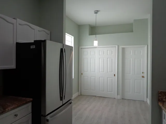 an empty room with closet and entryway