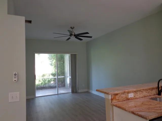 a view of room with window and wooden floor