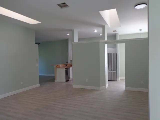 a view of a hallway with wooden shelves