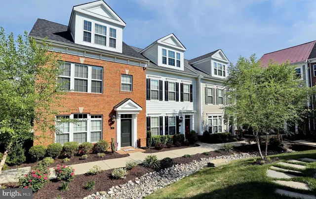a front view of a residential apartment building with a yard