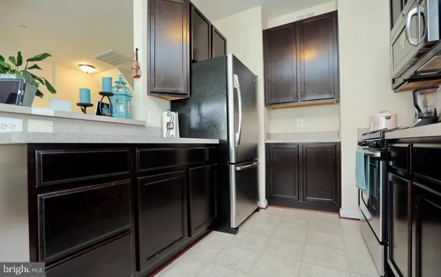 a kitchen with stainless steel appliances a refrigerator and a sink
