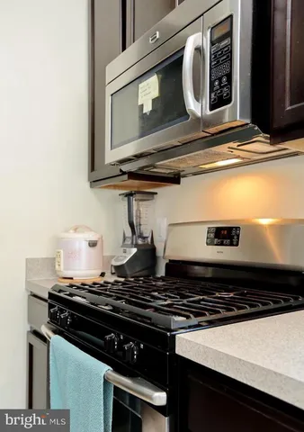 a stove top oven sitting inside of a kitchen