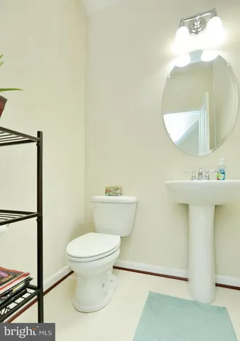 a bathroom with a toilet and a mirror