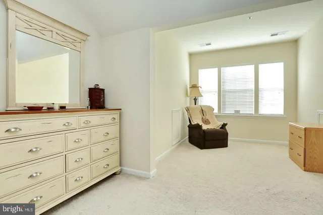 a room with a bed and a dresser