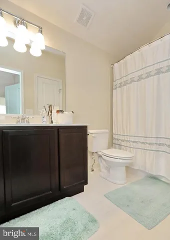 a bathroom with a sink a toilet and mirror