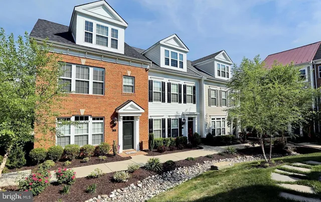 a front view of a residential apartment building with a yard