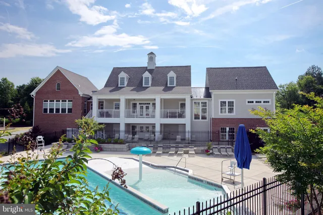 a front view of a house with yard and lake view