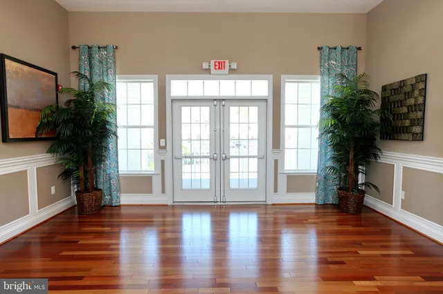a kitchen with a table chairs and wooden floor