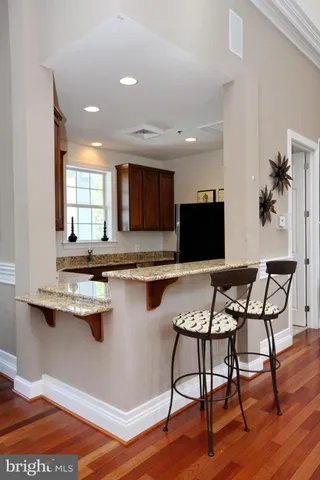 a kitchen with stainless steel appliances granite countertop wooden cabinets a sink and dishwasher