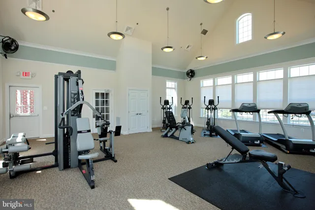 a room with gym equipment and a large mirror
