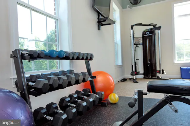 a room with gym equipment and windows