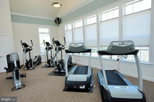 a room with a flat screen tv and gym equipment