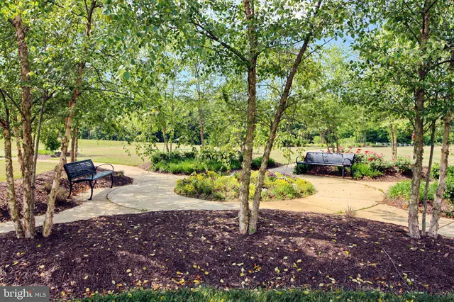 a backyard of a house with a patio table and chairs