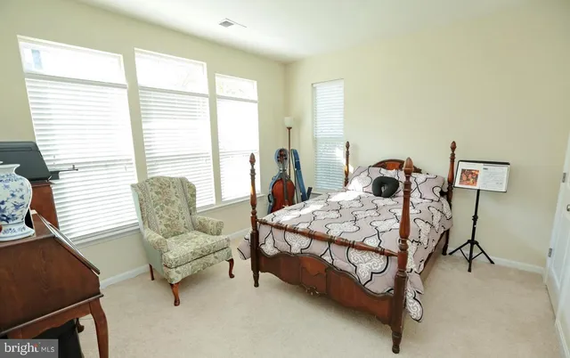 a bedroom with a bed chair and window