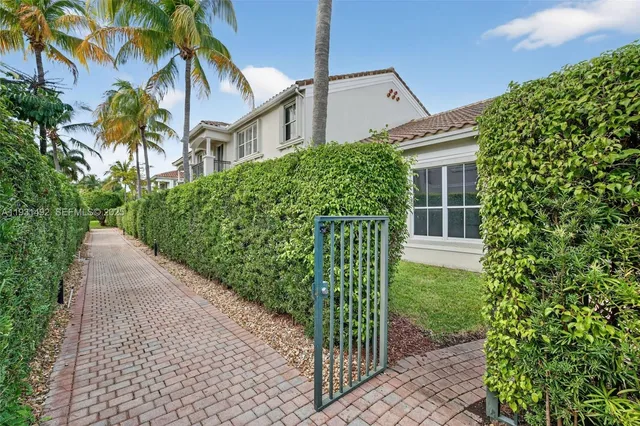 a view of a house with a small yard and plants