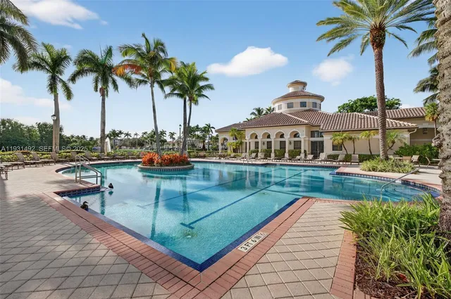a view of a swimming pool and lounge chairs