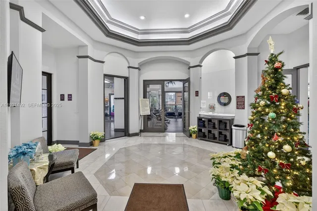 a living room with fireplace furniture and a chandelier