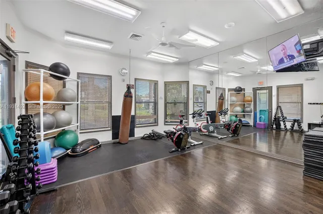 a gym room with lots of potted plants