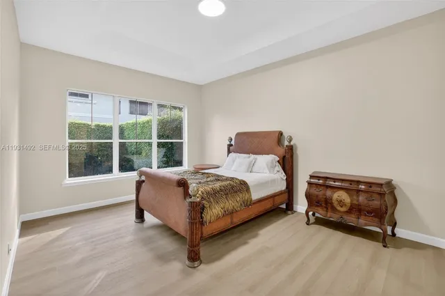 a bed sitting in a room next to a window