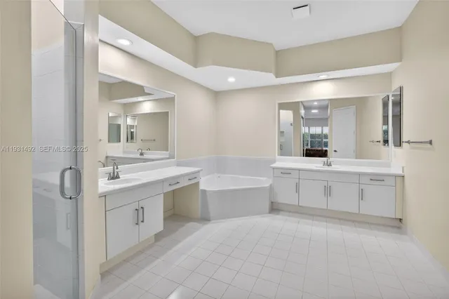 a spacious bathroom with a granite countertop sink a toilet a mirror and bathtub