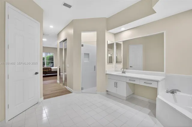 a large bathroom with a sink and a mirror