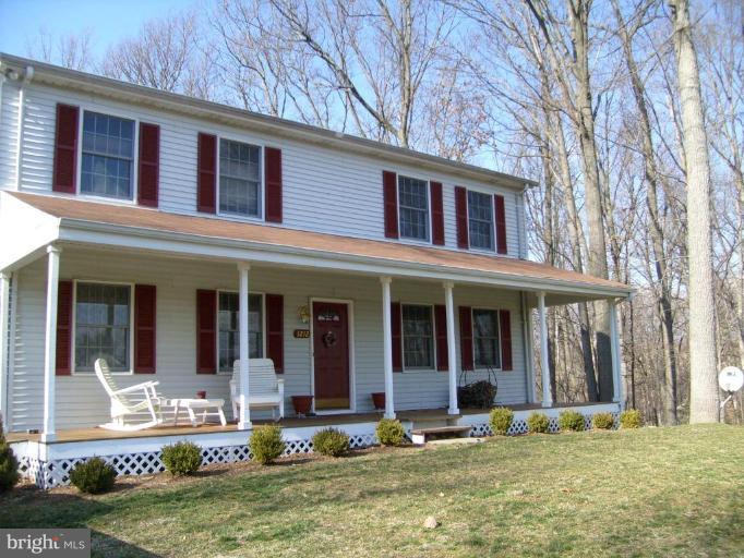 3212 Patapsco Road Finksburg, MD 21048 - Photo 1 of 26 front view of a brick house with a yard and large trees