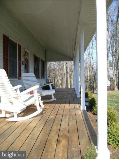 3212 Patapsco Road Finksburg, MD 21048 - Photo 3 of 26 a view of a patio with dining table and chairs with wooden floor