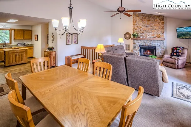 a living room with furniture a fireplace and a chandelier